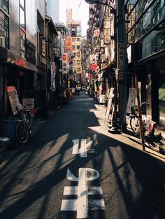 an empty city street with buildings and signs