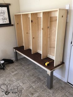 a bunch of wooden cabinets sitting on top of a tiled floor