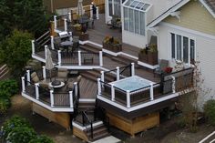 an aerial view of a house with deck and hot tub