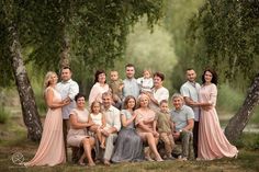 a family posing for a photo in front of some trees