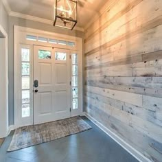 a white front door with a light hanging above it