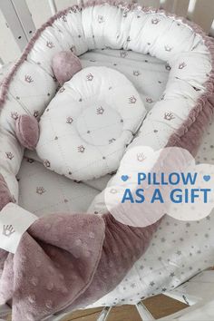 a baby crib with a pillow as a gift