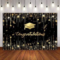 congratulations backdrop with gold stars and confetti on it in front of a wooden floor