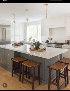 a large kitchen island with stools in front of it