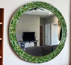 a mirror hanging on the wall above a couch