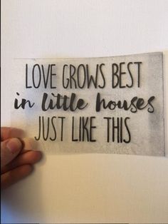 someone holding up a piece of paper that says love grows best in little houses just like this