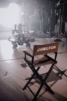 a director's chair sitting on the floor in front of a camera set up