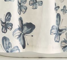 a close up of a curtain with butterfly designs on it's back and sides