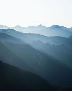 the mountains are covered in fog and light