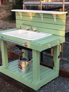 an outdoor sink with two buckets on it