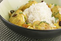 a bowl filled with rice and chicken on top of a tablecloth covered table cloth