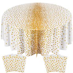 a white table with gold polka dots on it and four napkins in the middle