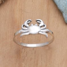 Designed with a scuttling crab, this delicate band ring from Dewa Arimbawa symbolizes protection, trust, and the cyclical nature of life. The Balinese artisan uses sterling silver to hand craft the ring, centering its slender band with the resilient sea creature. Crab Ring, Crab Jewelry, Sterling Silver Rings Bands, Sea Creature, Hand Craft, Ring Collection, Silver Band Ring, Men's Ring, Balinese