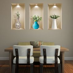 three vases on the wall above a dining table