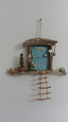 a small blue door on top of a wooden shelf