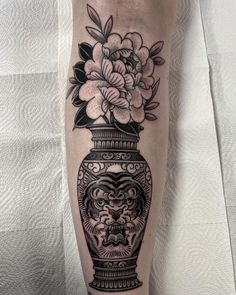 a vase with flowers in it on the leg