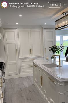 a large kitchen with white cabinets and marble counter tops is featured in this image from the website