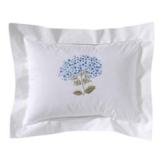 a white pillow with blue flowers on it