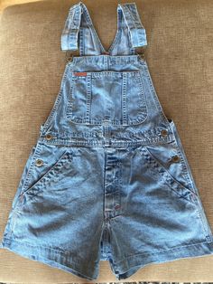 Ikeda shorteralls. Size xs. In good vintage condition. 11 inch short length from top of the pocket down. 15 inches across the waist. 10.5 inch rise. 16.5 inch across the hip from second button down across to the same button on the other side. Cheap High Waist Medium Wash Shortalls, Casual Cheap Shortalls With Button Closure, Affordable Denim Shortalls, Cheap Shortalls With Pockets, Cheap Fitted Shortalls With Pockets, Cheap Shortalls With Buttons For Spring, Playful Cheap Shortalls, Cheap Spring Shortalls With Buttons, Cheap Trendy Blue Shortalls