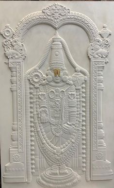 an intricately carved white wall panel