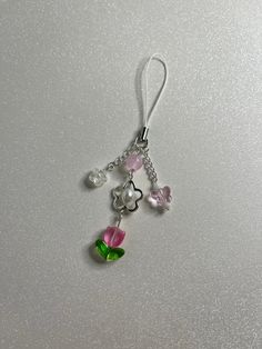 Handmade phone charm featuring glass tulip beads, glass butterfly bead, and plastic pearl beads attached to a white phone charm strap! This item can also be made with a keychain clasp instead, just let me know! ❀Canadian Customers- Standard default shipping ($2) *does not* include tracking as it is sent as untracked lettermail (via stamp). Upgraded shipping can be purchased at checkout, which includes tracking! Orders can take from 3-10+ business days to arrive if sent with standard shipping! ❀U Cute Diy Keychain Ideas, Tulip Phone Charm, Phone Charm Tutorial, White Phone Charm, Tulip Keychain, Pearl Phone Charm, Tulip Beads, Coquette Kawaii, Phone Keychain