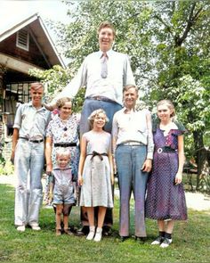 an old photo of a family posing for a picture in the grass with their children