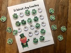 a st patrick's day counting game with shamrocks and clovers on the table