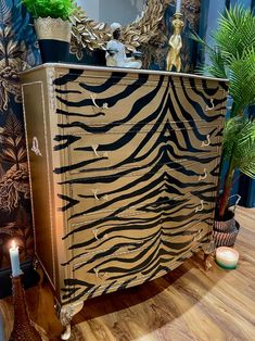 a zebra print dresser with candles on top