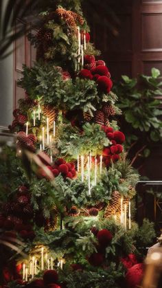 a christmas tree decorated with candles and ornaments