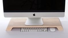 an apple computer sitting on top of a wooden desk