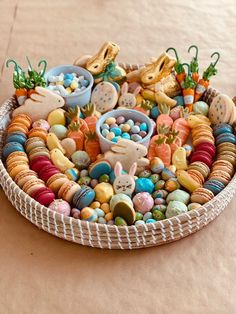 a basket filled with lots of different types of cookies and candies on top of a table