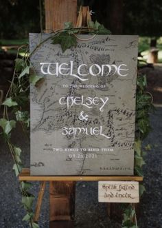 a welcome sign with greenery on it