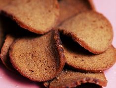 a pile of crackers sitting on top of a pink plate next to each other