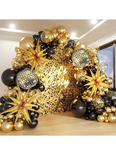 black and gold balloons are arranged in the shape of an arch with stars on it