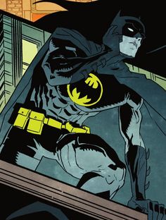 the batman is standing in front of a building with his bat on it's chest