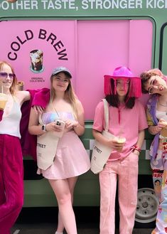 three girls in matching outfits standing next to a food truck with ice cream cones on their heads