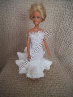 the doll is wearing a white dress