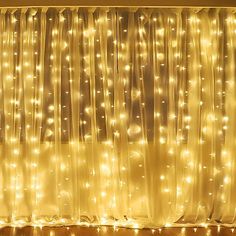 a living room filled with lots of lights next to a window covered in sheer curtains