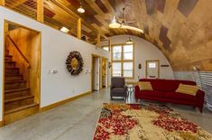 a living room filled with furniture next to a fire hydrant and wooden ceilinging