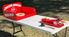 a table that has some kind of food on top of it and is sitting in the grass