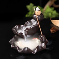 a candle that is sitting on top of a plate with a stick sticking out of it