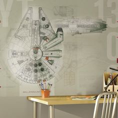 a desk and chair in front of a wall with a drawing of a star trek ship on it