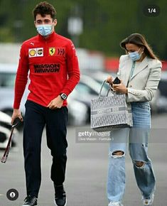 a man wearing a face mask walking with a woman