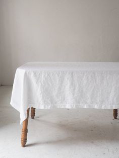 a white table cloth with wooden legs