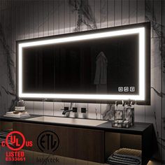 a bathroom with a large lighted mirror above the sink