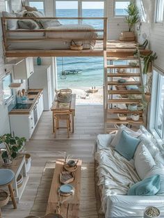 a living room filled with lots of furniture next to an ocean side house on stilts