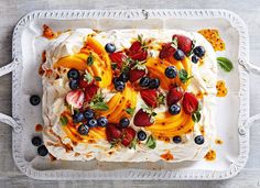 a cake with fruit on top is sitting on a tray