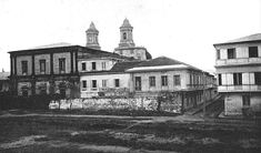 an old black and white photo of two buildings with steeples on the top floors