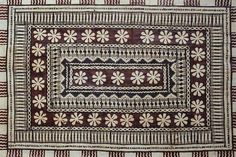 a brown and white rug with flowers on the bottom, surrounded by lines and dots