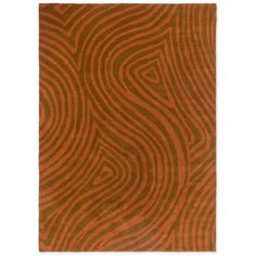 an orange and brown area rug with wavy lines on the side, in front of a white background